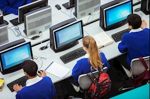 Elevated view of students sitting and learning in computer room stock photo