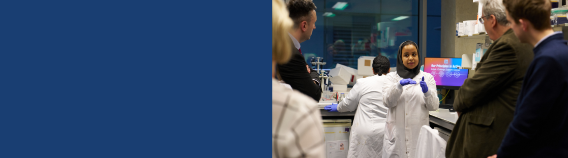 female researcher explains her work in a lab 