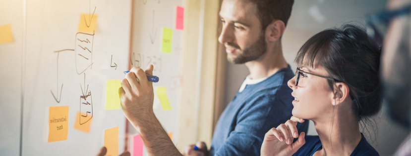 two people looking at a whiteboard