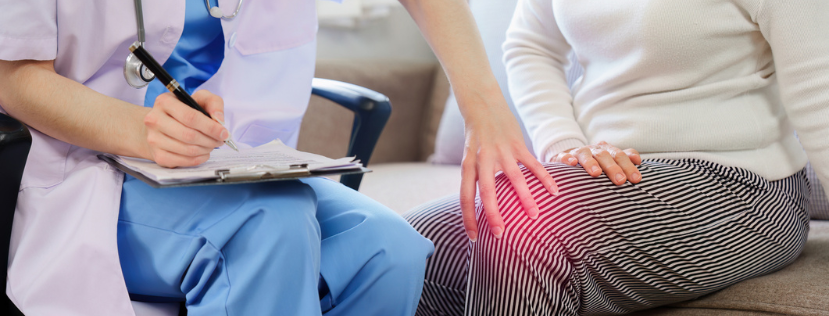 doctor touching women's knee which is in pain