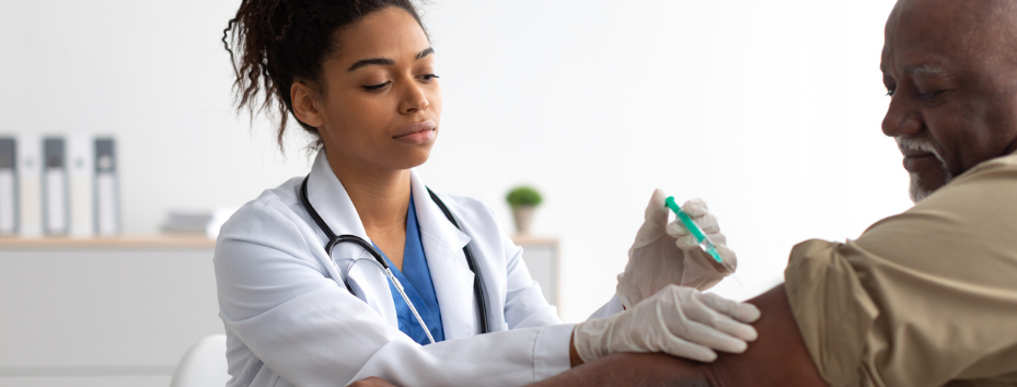 Senior Patient Getting Vaccinated  Sitting In Medical Center