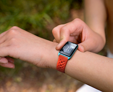 person wearing a digital wristwatch which also measures activity