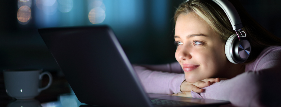 young girl watches something on her laptop